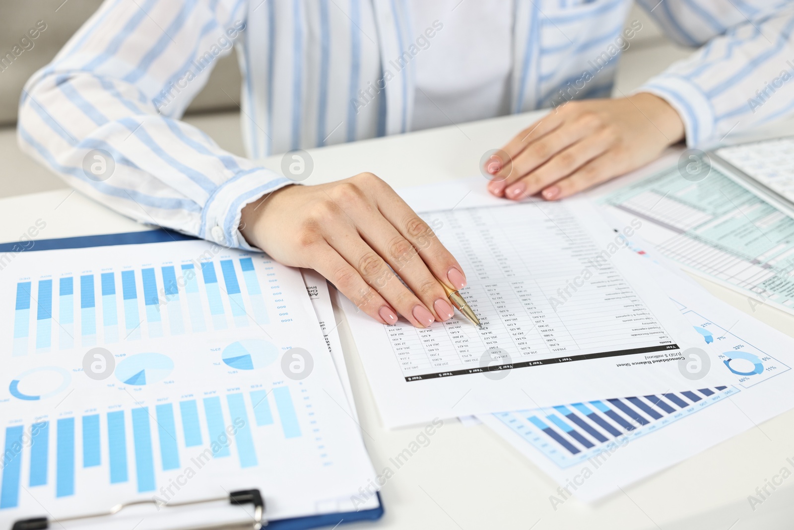 Photo of Budget planning. Woman with papers at white table, closeup