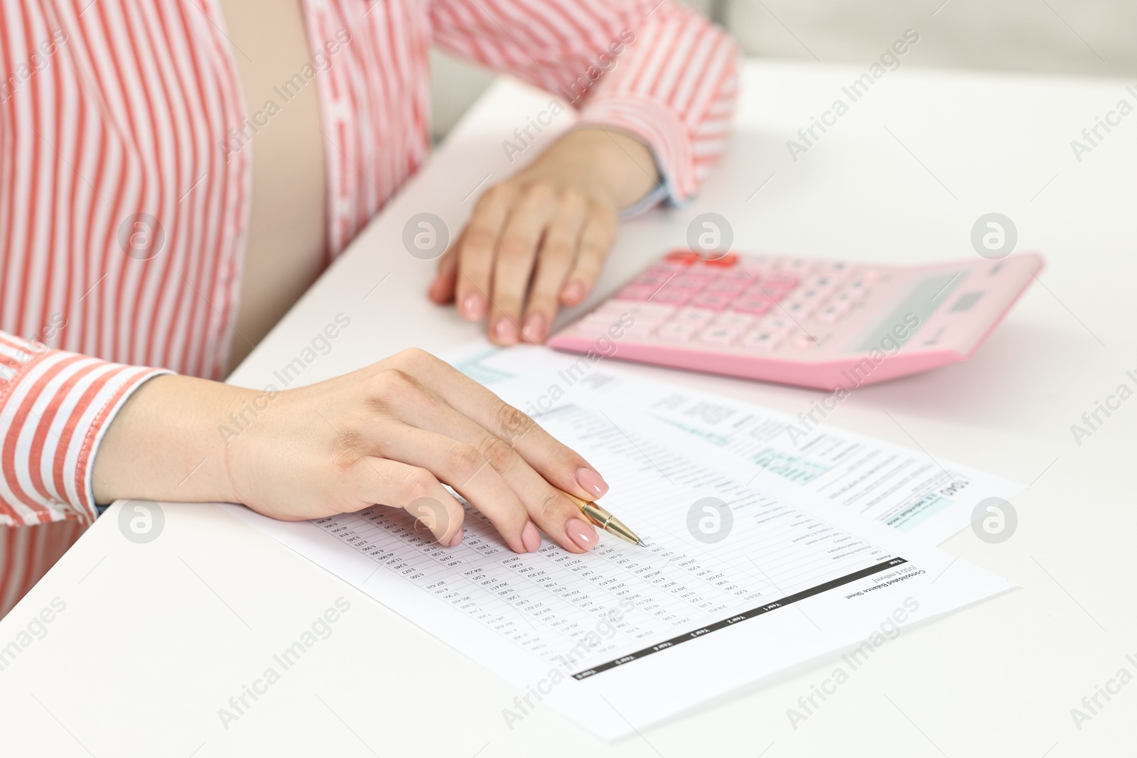 Photo of Budget planning. Woman with papers at white table, closeup