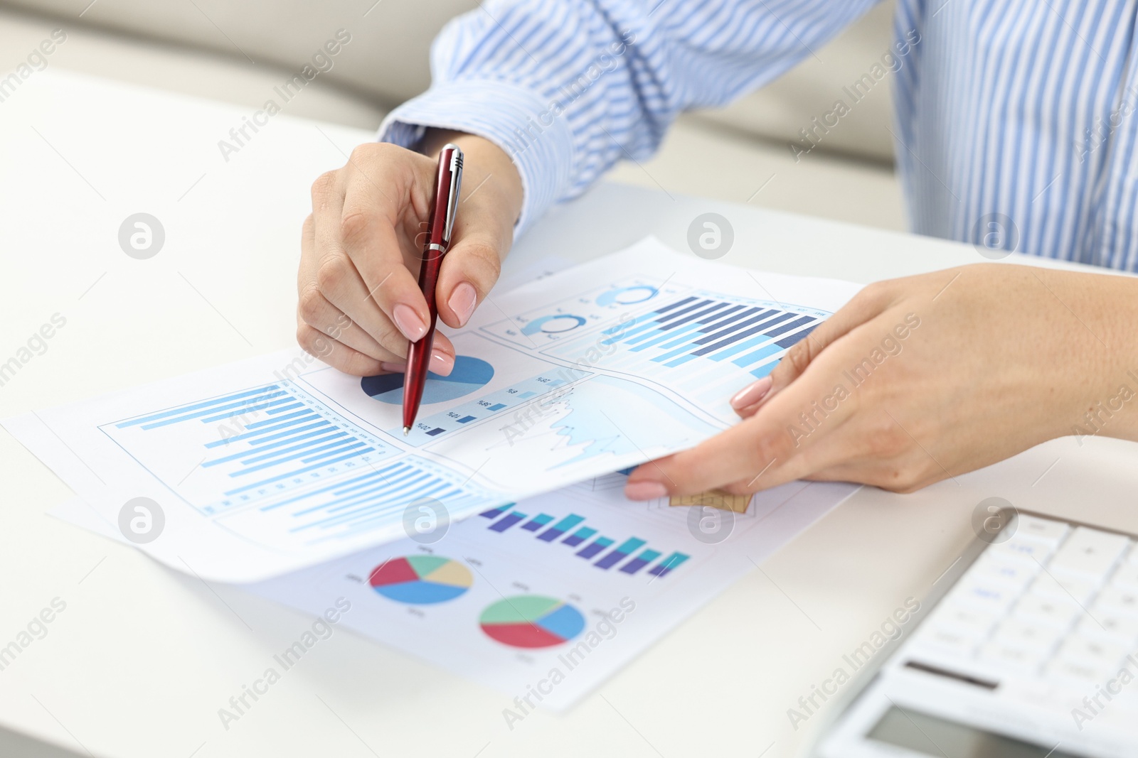 Photo of Budget planning. Woman with papers at white table, closeup