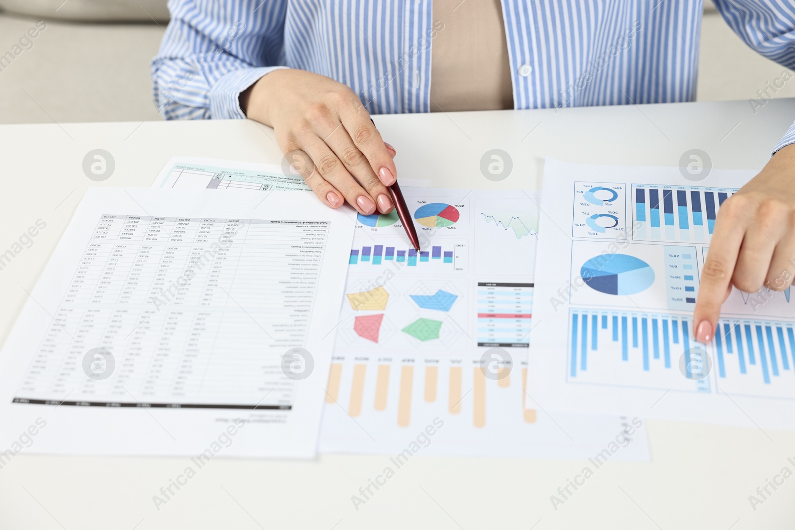 Photo of Budget planning. Woman with papers at white table, closeup