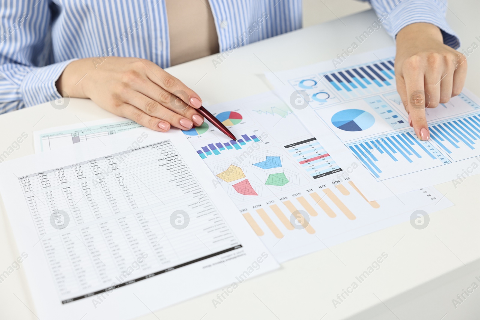 Photo of Budget planning. Woman with papers at white table, closeup