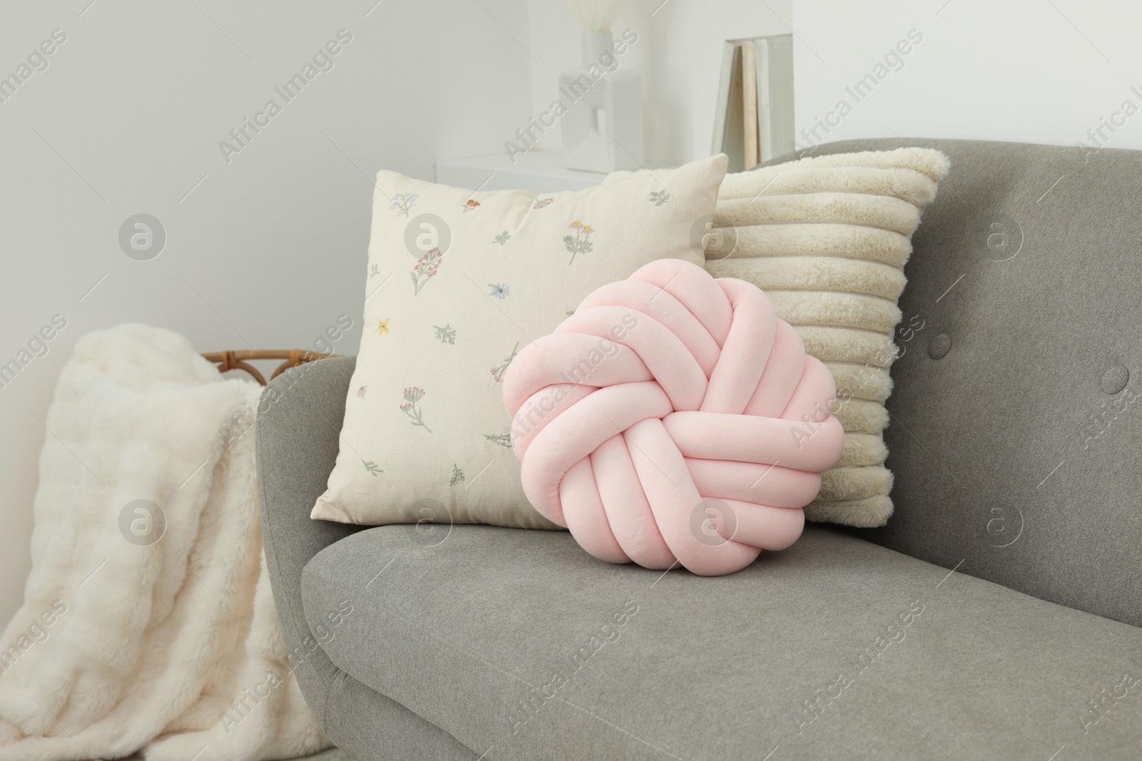 Photo of Different soft pillows on sofa in room