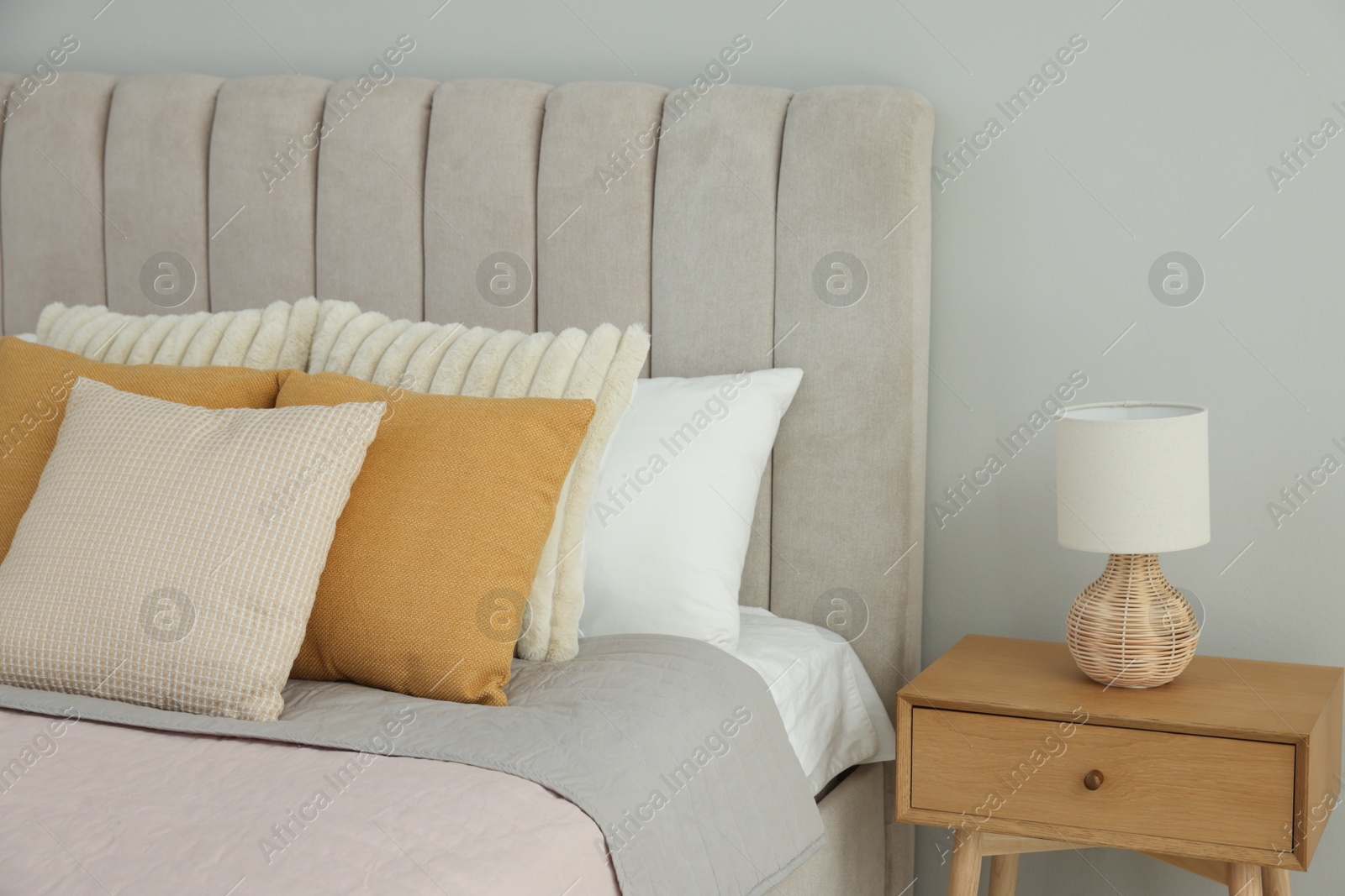 Photo of Different soft pillows on bed in room