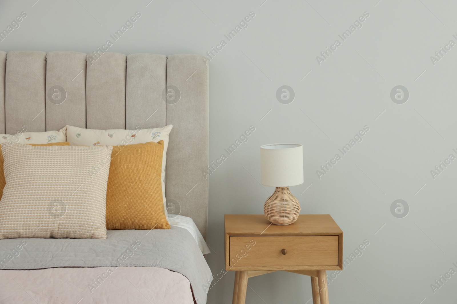 Photo of Different soft pillows on bed in room