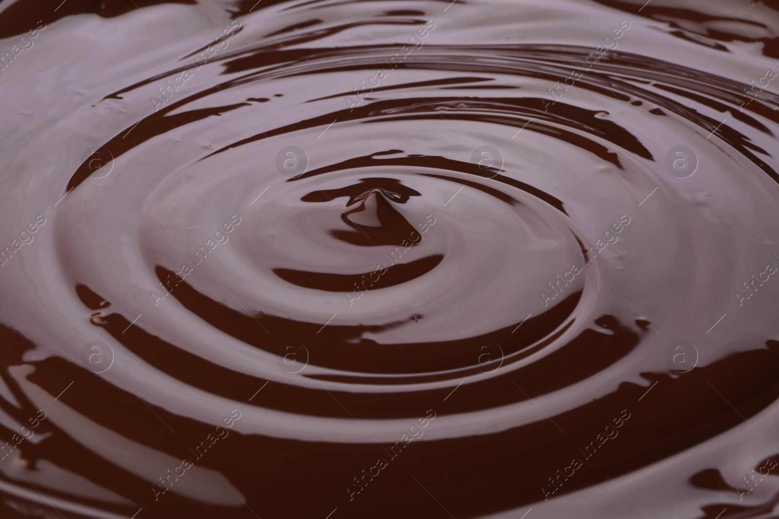 Photo of Tasty melted chocolate as background, closeup view