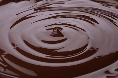 Photo of Tasty melted chocolate as background, closeup view