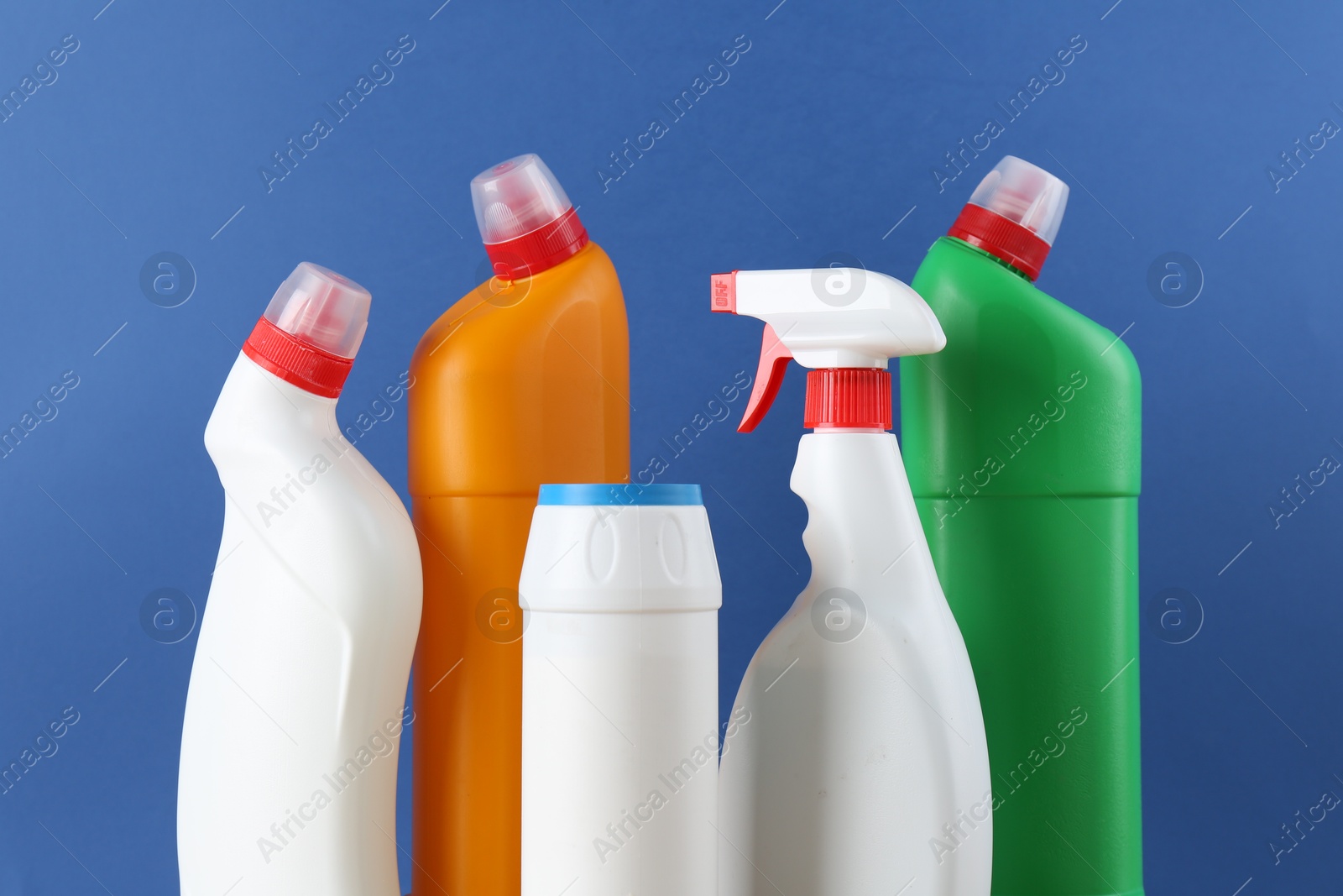 Photo of Different toilet cleaners on blue background, closeup