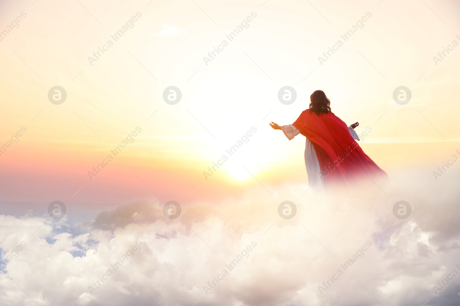 Image of Jesus Christ in sunlight among clouds in sky