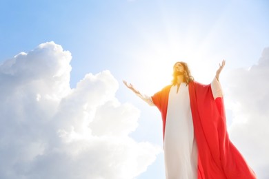 Jesus Christ in sunlight among clouds in sky