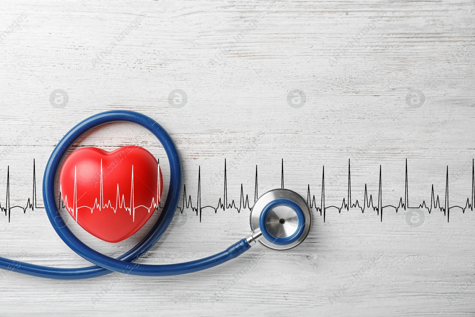 Image of Red decorative heart, stethoscope and electrocardiogram on white wooden table, top view