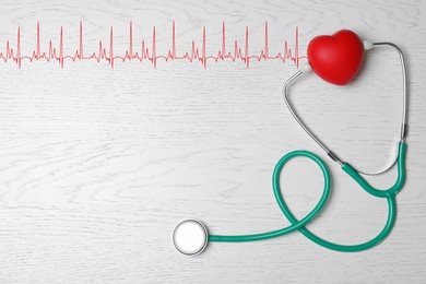 Image of Red decorative heart, stethoscope and electrocardiogram on white wooden table, top view