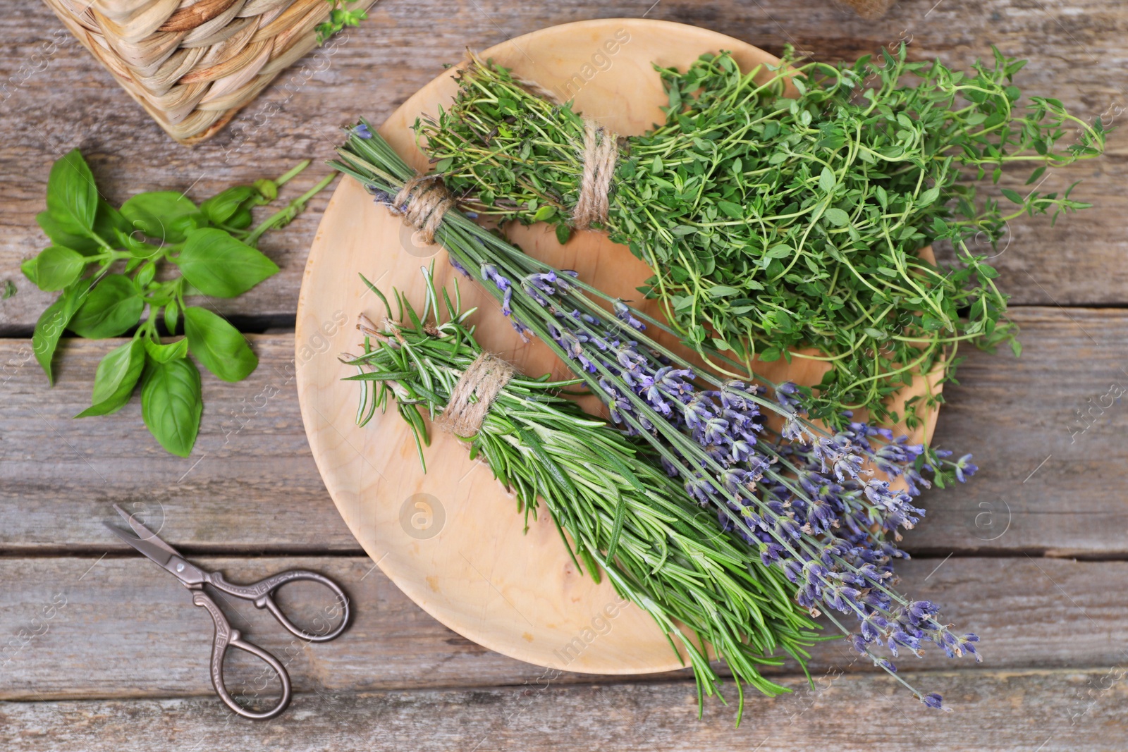 Photo of Different aromatic herbs and scissors on wooden table, flat lay