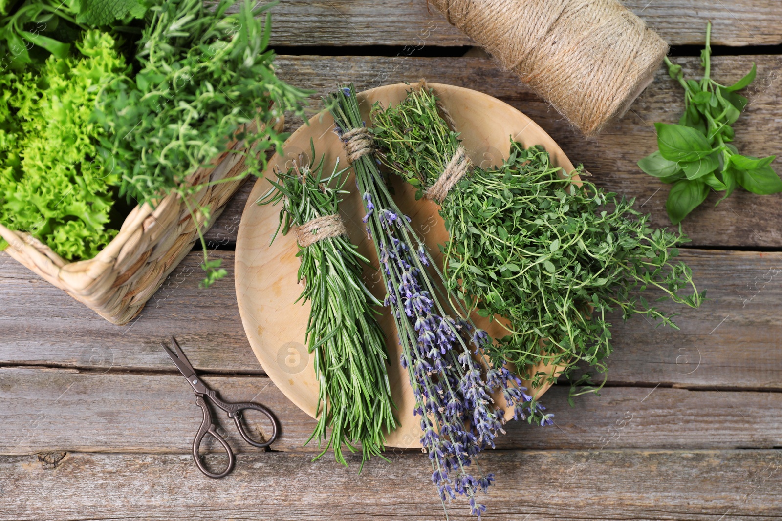 Photo of Different aromatic herbs and scissors on wooden table, flat lay