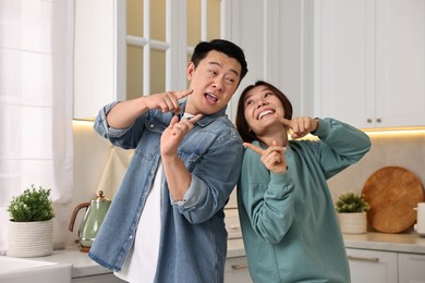 Happy lovely couple dancing together in kitchen