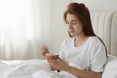 Photo of Woman adding essential oil to aroma diffuser at home