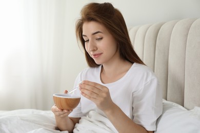 Woman adding essential oil to aroma diffuser at home