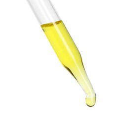 Dripping essential oil from pipette on white background