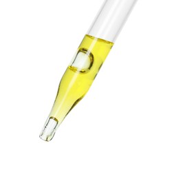 Dripping essential oil from pipette on white background