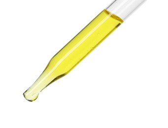 Photo of Dripping essential oil from pipette on white background