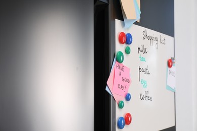 Magnetic board with shopping list and notes on refrigerator