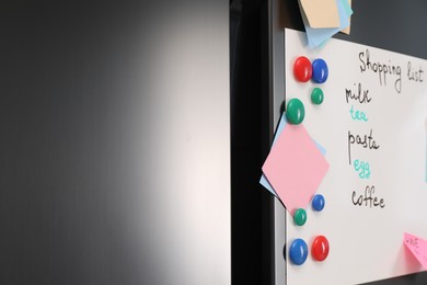 Photo of Magnetic board with shopping list and notes on refrigerator