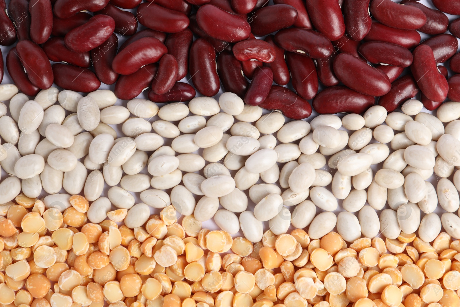 Photo of Different types of legumes as background, top view