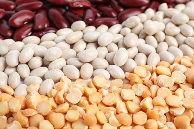 Photo of Different types of legumes as background, closeup