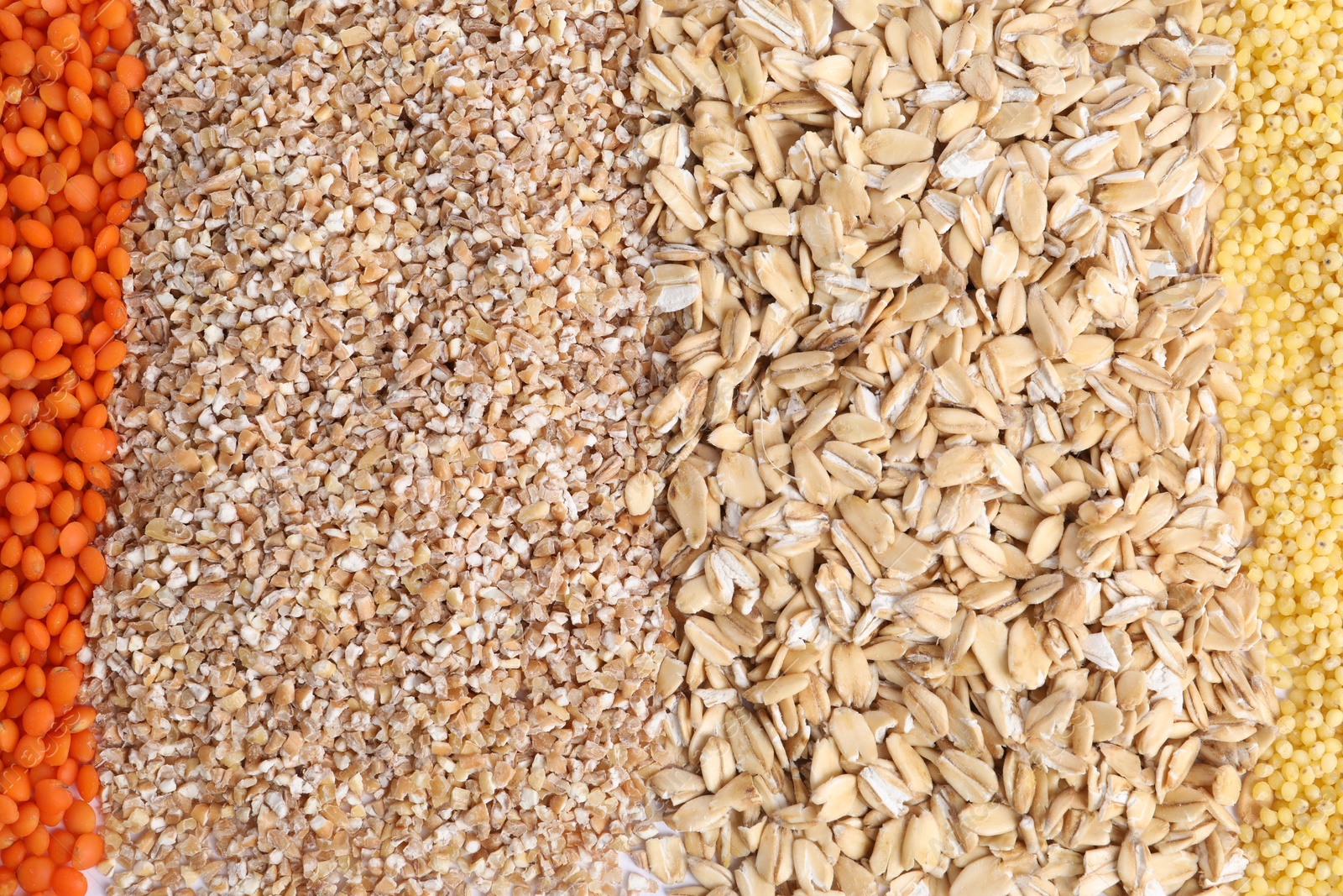 Photo of Different types of cereals and lentils as background, top view