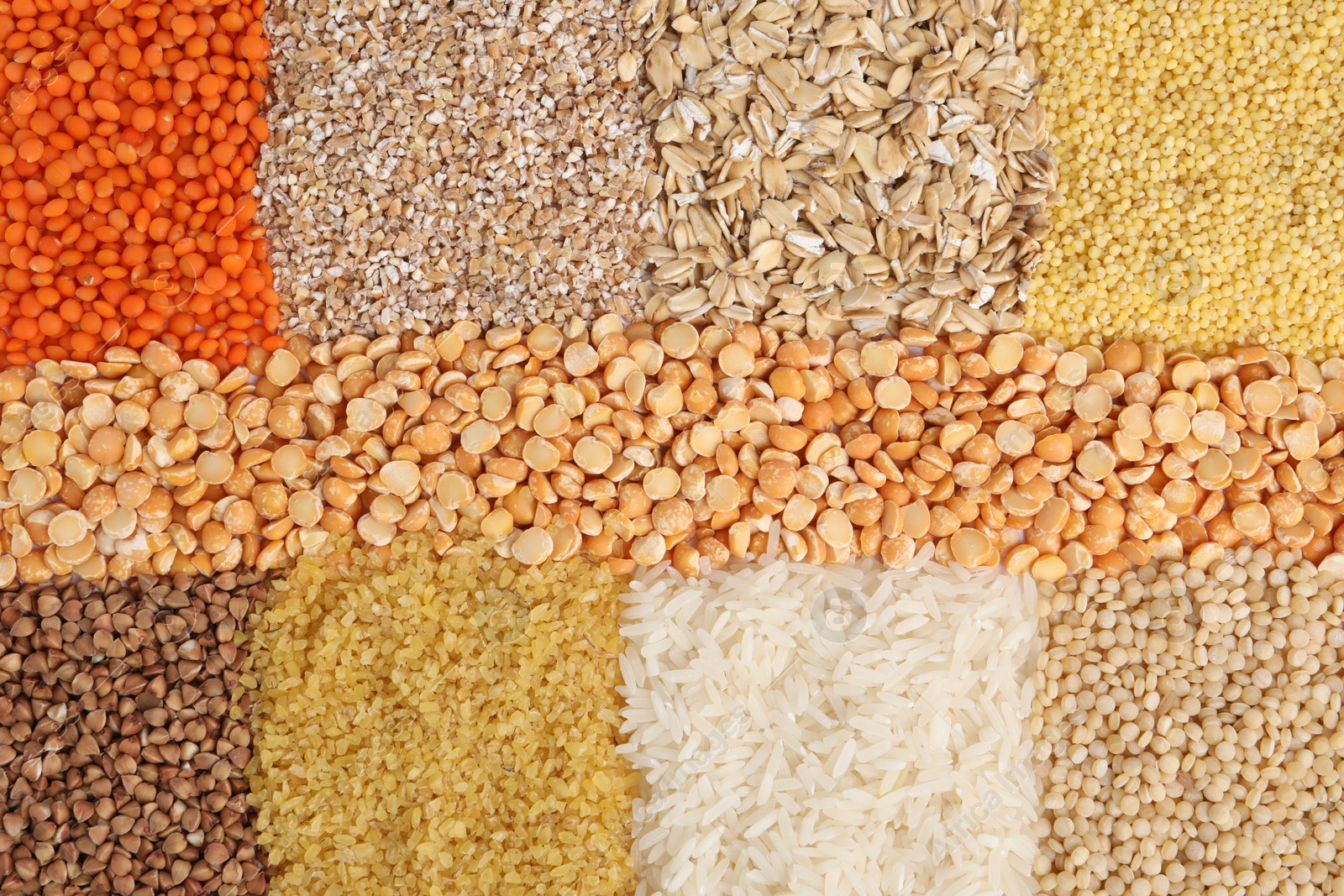 Photo of Different types of cereals and legumes as background, top view