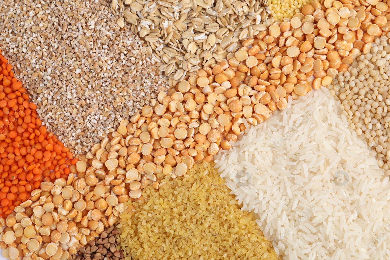 Photo of Different types of cereals and legumes as background, top view