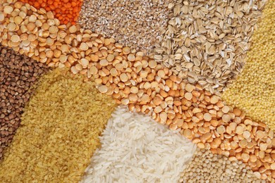 Different types of cereals and legumes as background, top view