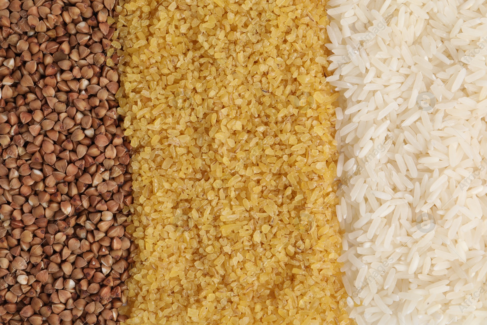 Photo of Different types of cereals as background, top view