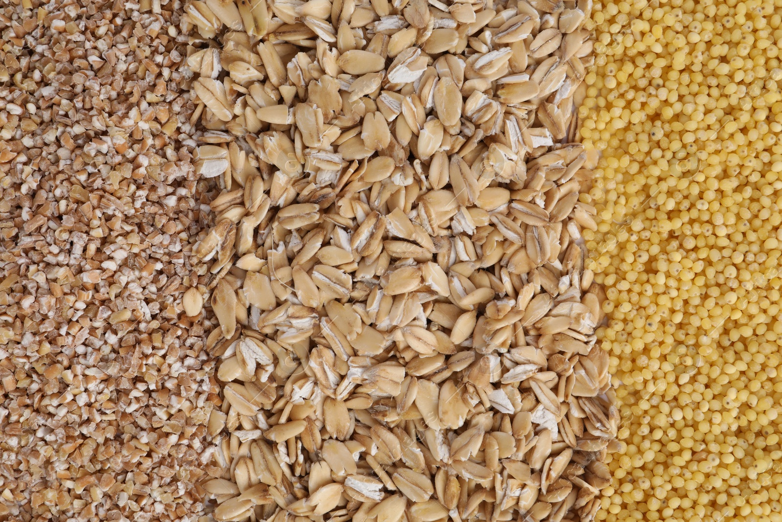 Photo of Different types of cereals as background, top view