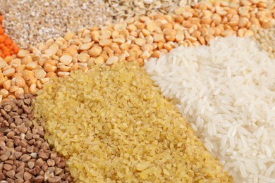 Photo of Different types of cereals and lentils as background, closeup