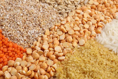 Photo of Different types of cereals and lentils as background, closeup