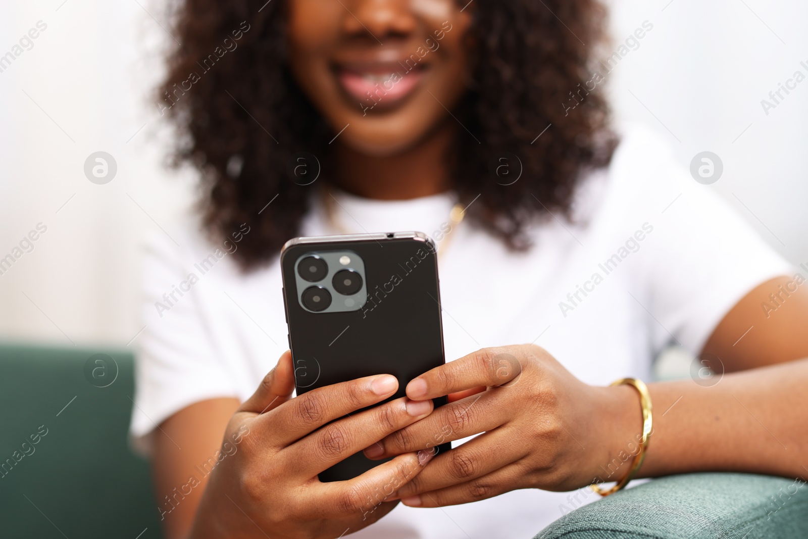 Photo of Woman using mobile phone at home, closeup