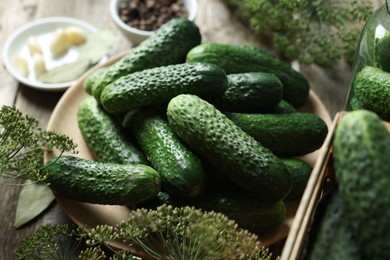 Fresh cucumbers and dill on wooden table, closeup. Preparation for pickling