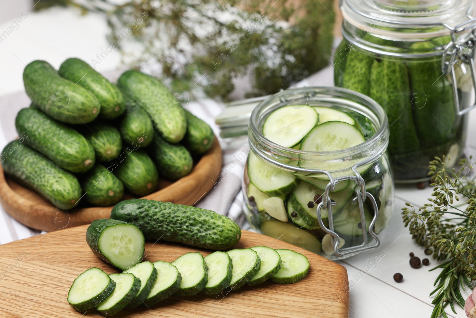 Photo of Fresh cucumbers on light table, closeup. Preparation for pickling