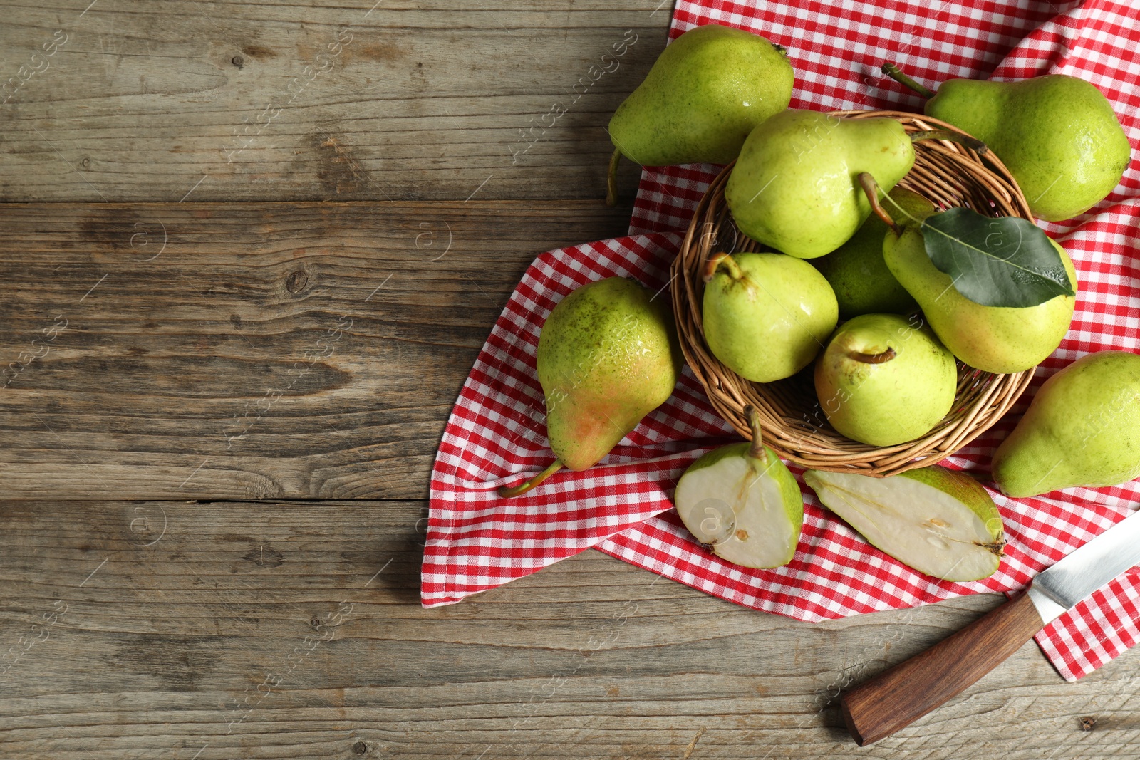 Photo of Fresh green pears and knife on wooden table, flat lay. Space for text