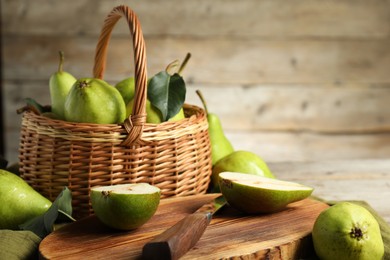 Photo of Fresh green pears and knife on table. Space for text