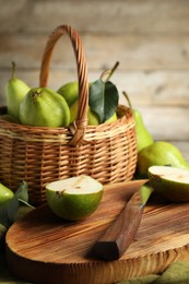 Photo of Fresh green pears, board and knife on table