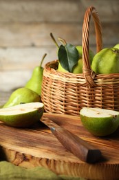 Photo of Fresh green pears, board and knife on table