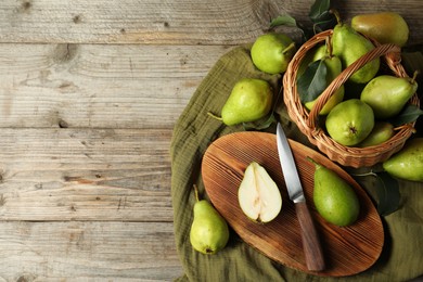 Photo of Fresh green pears, knife and napkin on wooden table, flat lay. Space for text