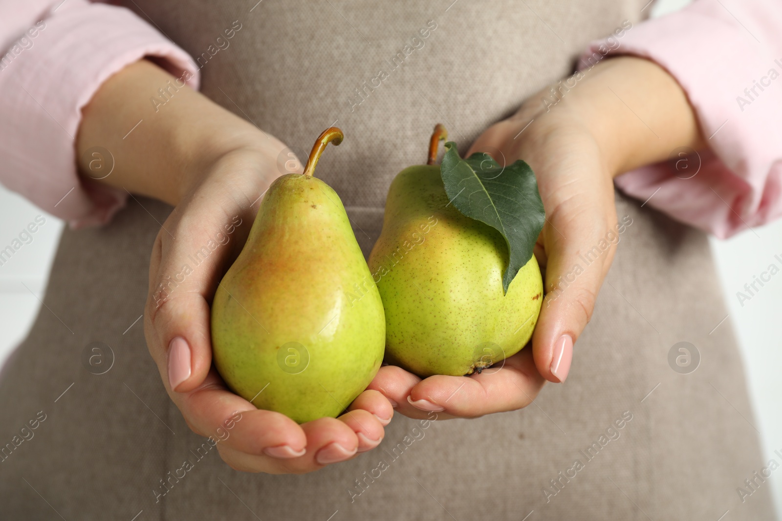 Photo of Woman with fresh green pears on white background, closeup