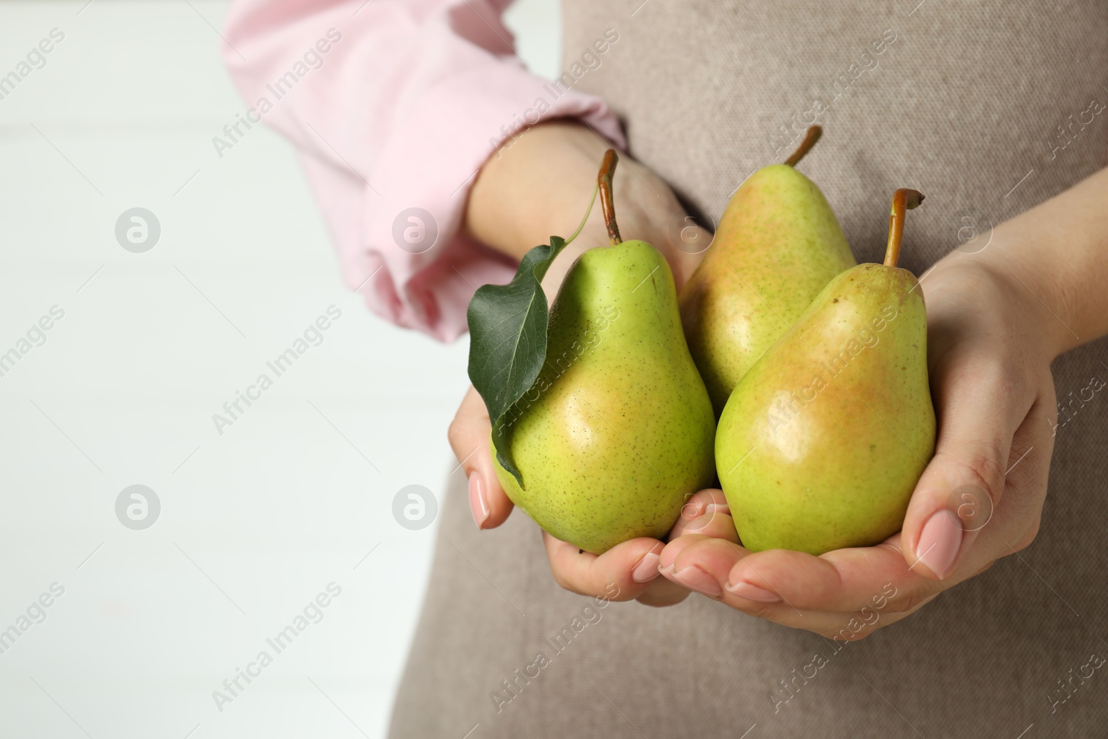 Photo of Woman with fresh green pears on white background, closeup. Space for text