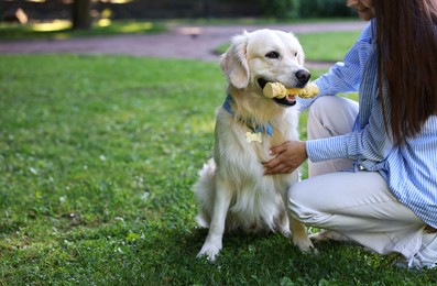 Photo of Owner with cute Golden Retriever dog outdoors, closeup. Space for text