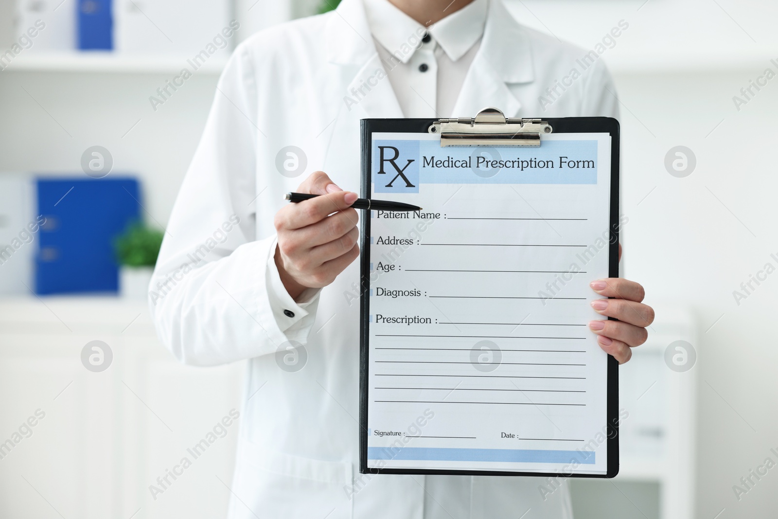 Photo of Doctor with blank prescription form in clinic, closeup