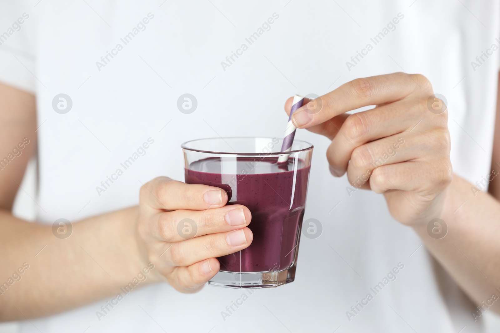 Photo of Woman with glass of tasty fresh acai juice, closeup