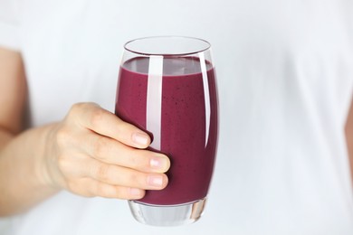 Photo of Woman with glass of tasty fresh acai juice, closeup