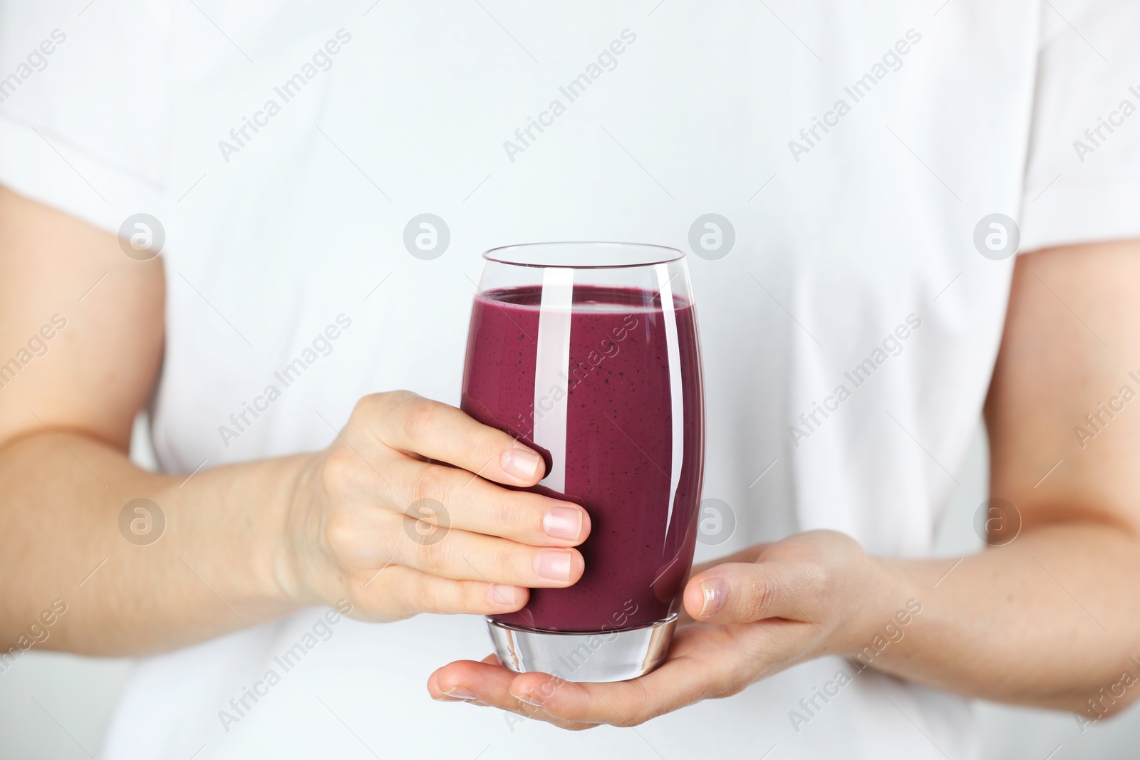 Photo of Woman with glass of tasty fresh acai juice, closeup